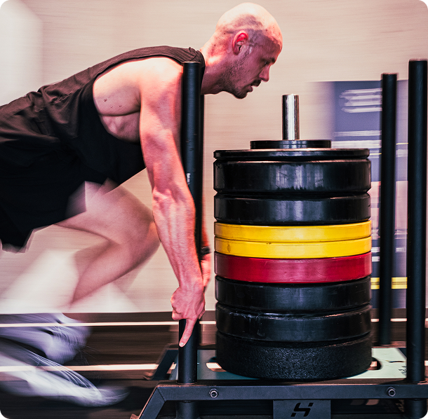 Athlete lifting weights during a HYROX simulation